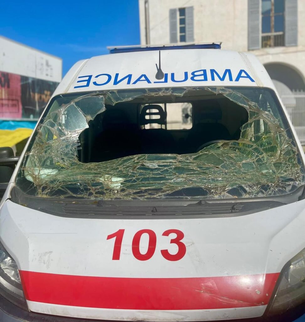 Ambulanza crivellata di fronte, esposta in piazza in Italia.